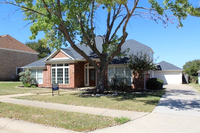 view of front of home with a front lawn and a garage