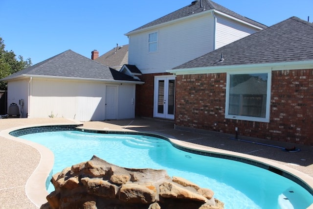 view of pool featuring french doors and a patio area