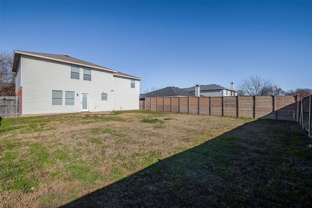 back of property featuring a yard