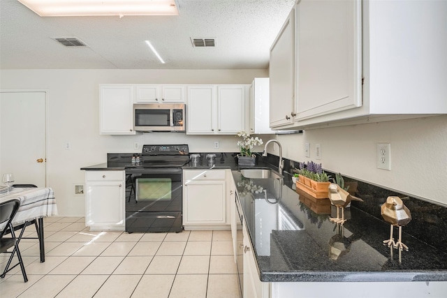 kitchen with a textured ceiling, sink, black electric range, white cabinetry, and light tile patterned flooring