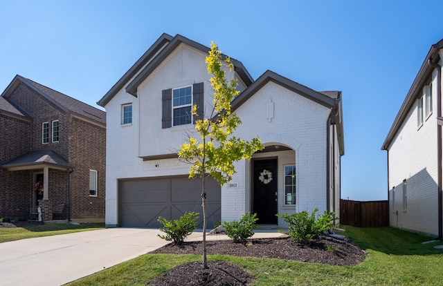 view of front of house with a garage and a front lawn