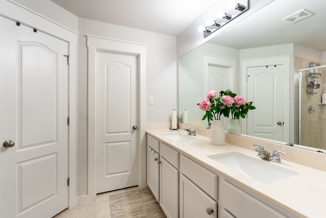 bathroom with vanity and a shower with shower door