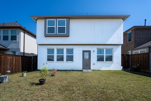 rear view of property with a yard