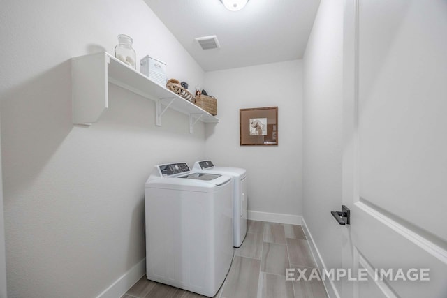 clothes washing area featuring washer and dryer and light hardwood / wood-style floors