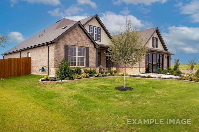 tudor-style house featuring a front lawn