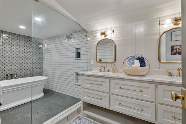 bathroom with tile walls, vanity, and separate shower and tub