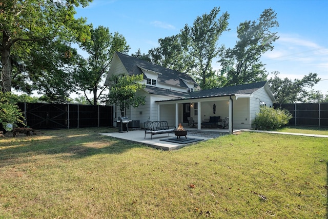 back of property featuring outdoor lounge area, a patio area, and a yard