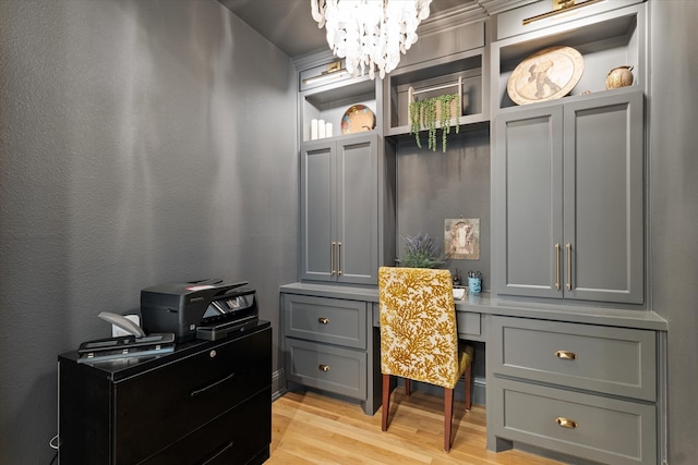 office with a notable chandelier and light wood-type flooring