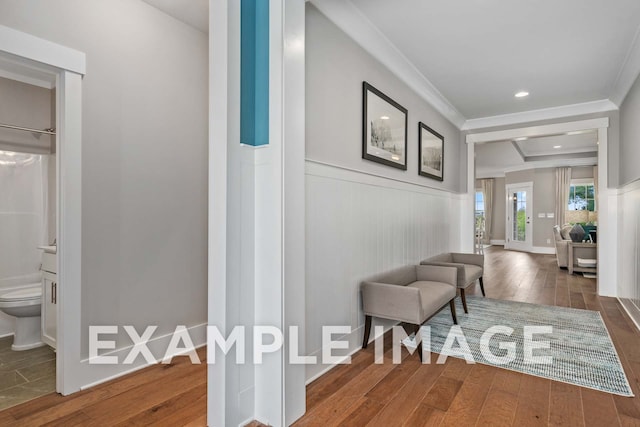 hall featuring crown molding, a wainscoted wall, and dark wood finished floors