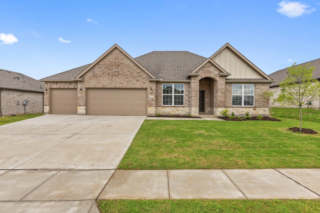 215 Briarwood Dr, Nevada, TX 75173 - view of front facade featuring a garage, a front yard, brick siding, board and batten siding, and concrete driveway