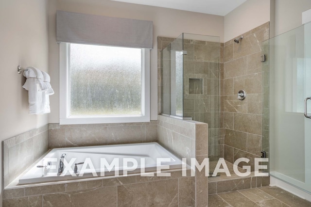 bathroom featuring shower with separate bathtub