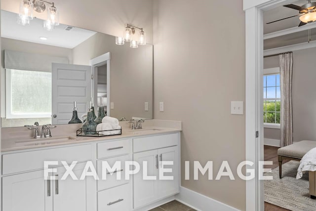 full bathroom featuring a sink, baseboards, and double vanity