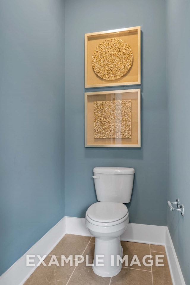 bathroom featuring tile patterned flooring and toilet