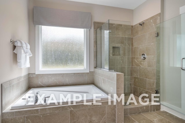 bathroom with a stall shower, a healthy amount of sunlight, a garden tub, and tile patterned flooring