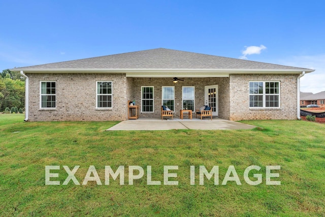 back of property featuring a ceiling fan, a patio area, a yard, and brick siding