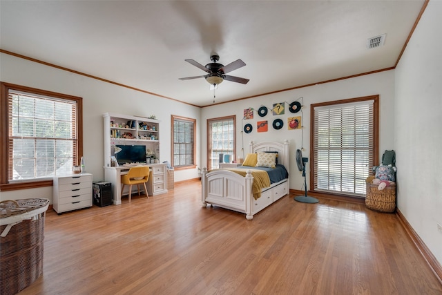 bedroom with ceiling fan, crown molding, and light hardwood / wood-style floors