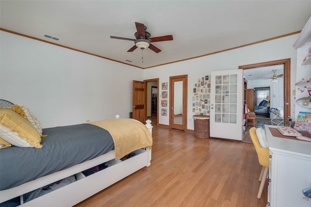 bedroom with ceiling fan, crown molding, french doors, and light wood-type flooring