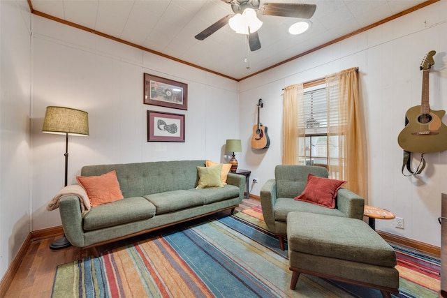 living room featuring ceiling fan, ornamental molding, and wood-type flooring