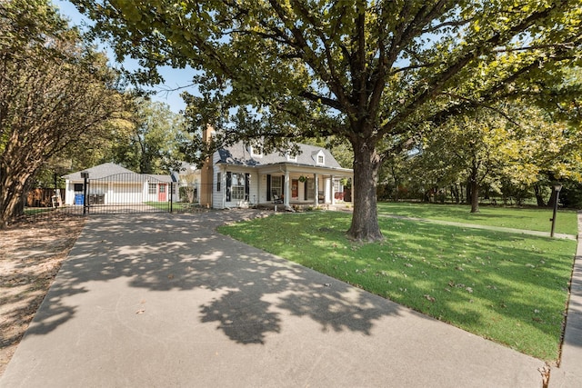 view of front facade featuring a garage, covered porch, and a front yard