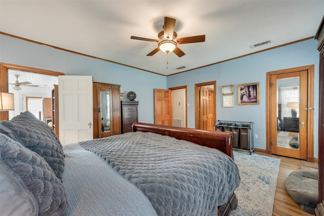 bedroom with light wood-type flooring, ceiling fan, and ornamental molding