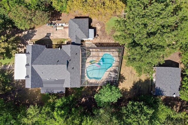 view of swimming pool featuring glass enclosure and a patio area