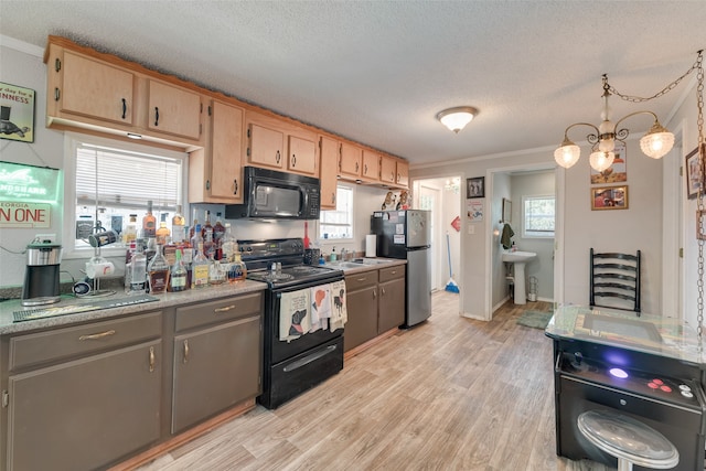 kitchen featuring a notable chandelier, hanging light fixtures, a textured ceiling, ornamental molding, and black appliances