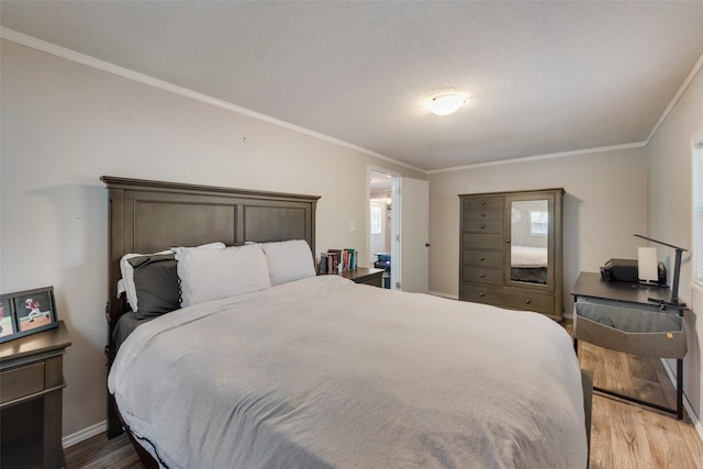 bedroom with crown molding, a textured ceiling, and hardwood / wood-style floors