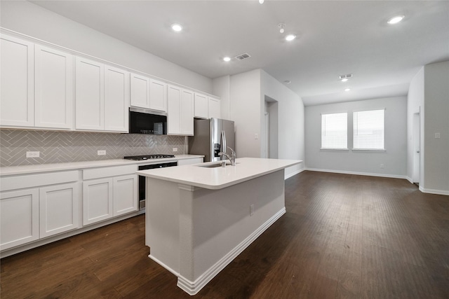 kitchen featuring stainless steel refrigerator with ice dispenser, a kitchen island with sink, range, and white cabinets