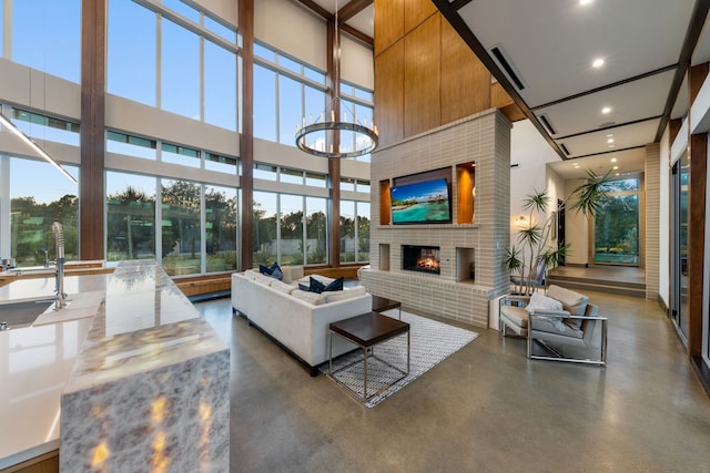 10150 Marsh Ln, Dallas, TX 75229 - living area featuring recessed lighting, concrete floors, a brick fireplace, and a towering ceiling
