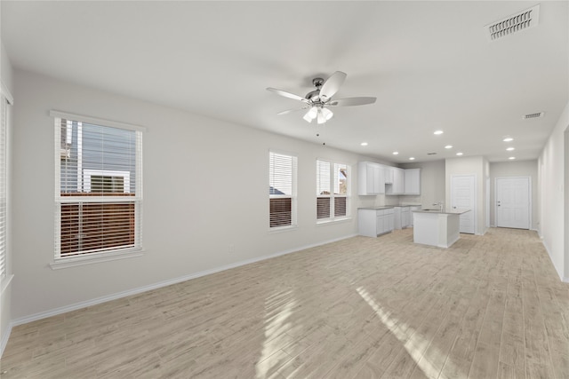 unfurnished living room featuring light hardwood / wood-style floors and ceiling fan