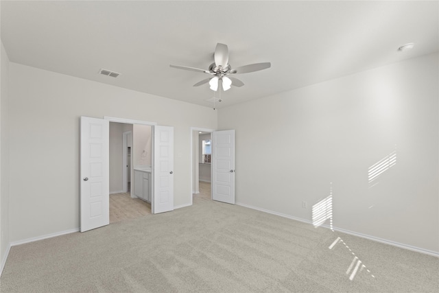 unfurnished bedroom featuring ceiling fan and light carpet