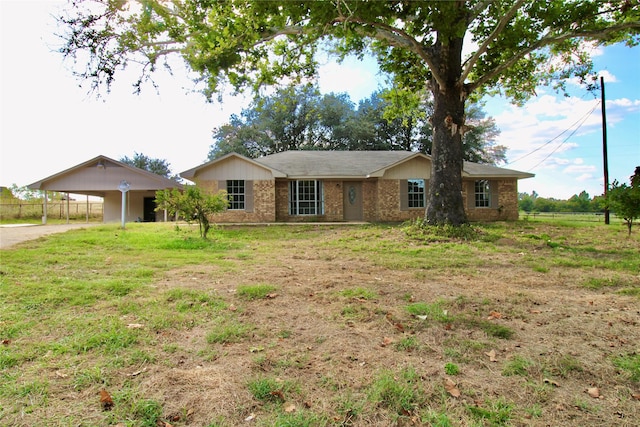 ranch-style home with a front yard and a carport