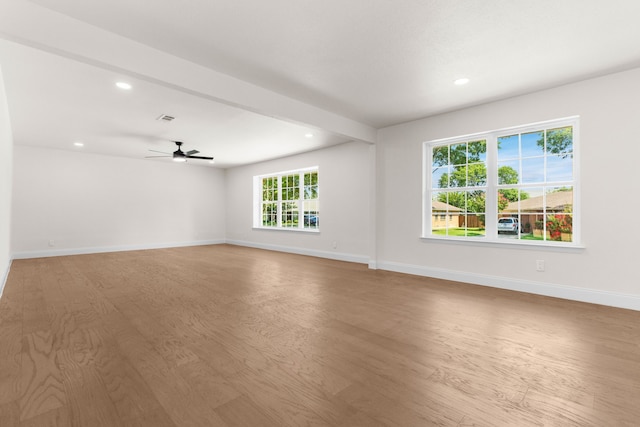 empty room with light wood-type flooring and ceiling fan