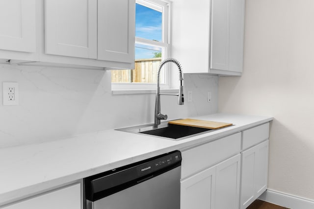 kitchen featuring white cabinets, sink, and dishwasher