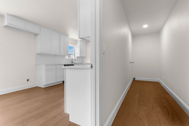 hall featuring light hardwood / wood-style flooring and sink