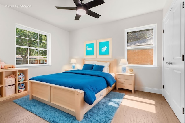 bedroom featuring light wood-type flooring and ceiling fan