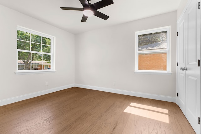 empty room with hardwood / wood-style flooring and ceiling fan