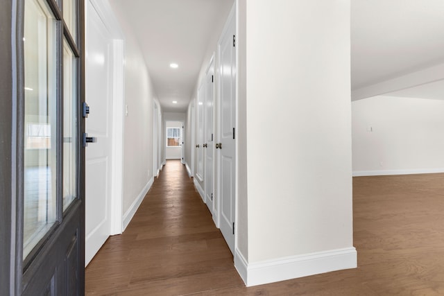 hallway with dark wood-type flooring