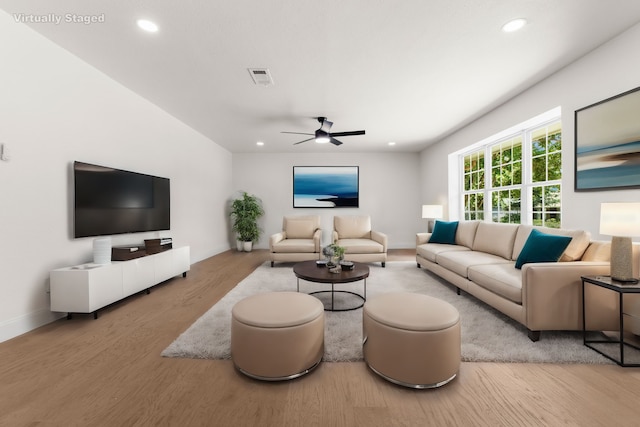 living room with light hardwood / wood-style floors and ceiling fan