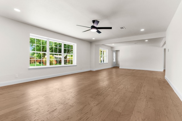 unfurnished living room with ceiling fan and light hardwood / wood-style flooring