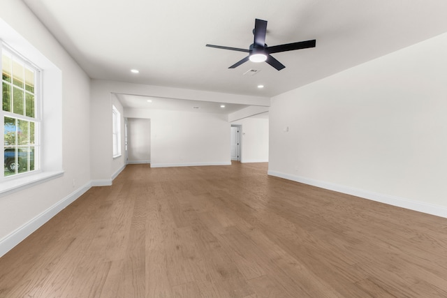 unfurnished living room featuring ceiling fan and light hardwood / wood-style floors