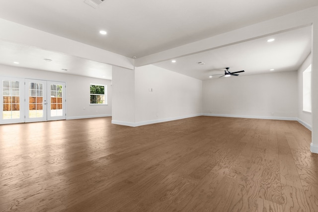 unfurnished room with french doors, beamed ceiling, hardwood / wood-style flooring, and ceiling fan