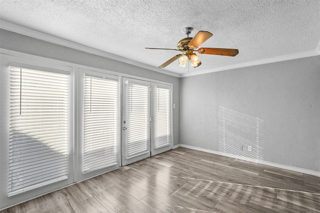 spare room with a textured ceiling, crown molding, ceiling fan, and hardwood / wood-style flooring