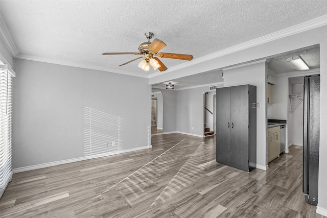 unfurnished living room featuring a textured ceiling, ornamental molding, ceiling fan, and hardwood / wood-style flooring