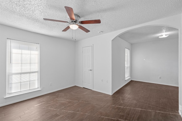 spare room featuring a textured ceiling, dark hardwood / wood-style floors, and ceiling fan