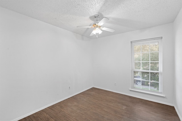 unfurnished room with a textured ceiling, ceiling fan, and dark wood-type flooring