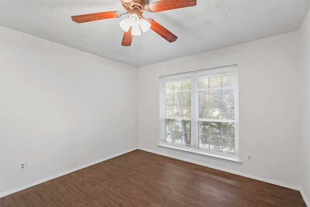 empty room with a textured ceiling, dark hardwood / wood-style floors, and ceiling fan