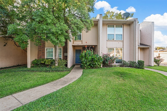 view of property featuring a front lawn