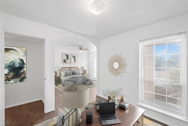 interior space featuring a textured ceiling, hardwood / wood-style flooring, and ceiling fan