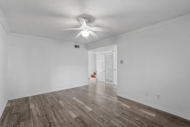 empty room featuring ornamental molding, a textured ceiling, and hardwood / wood-style floors